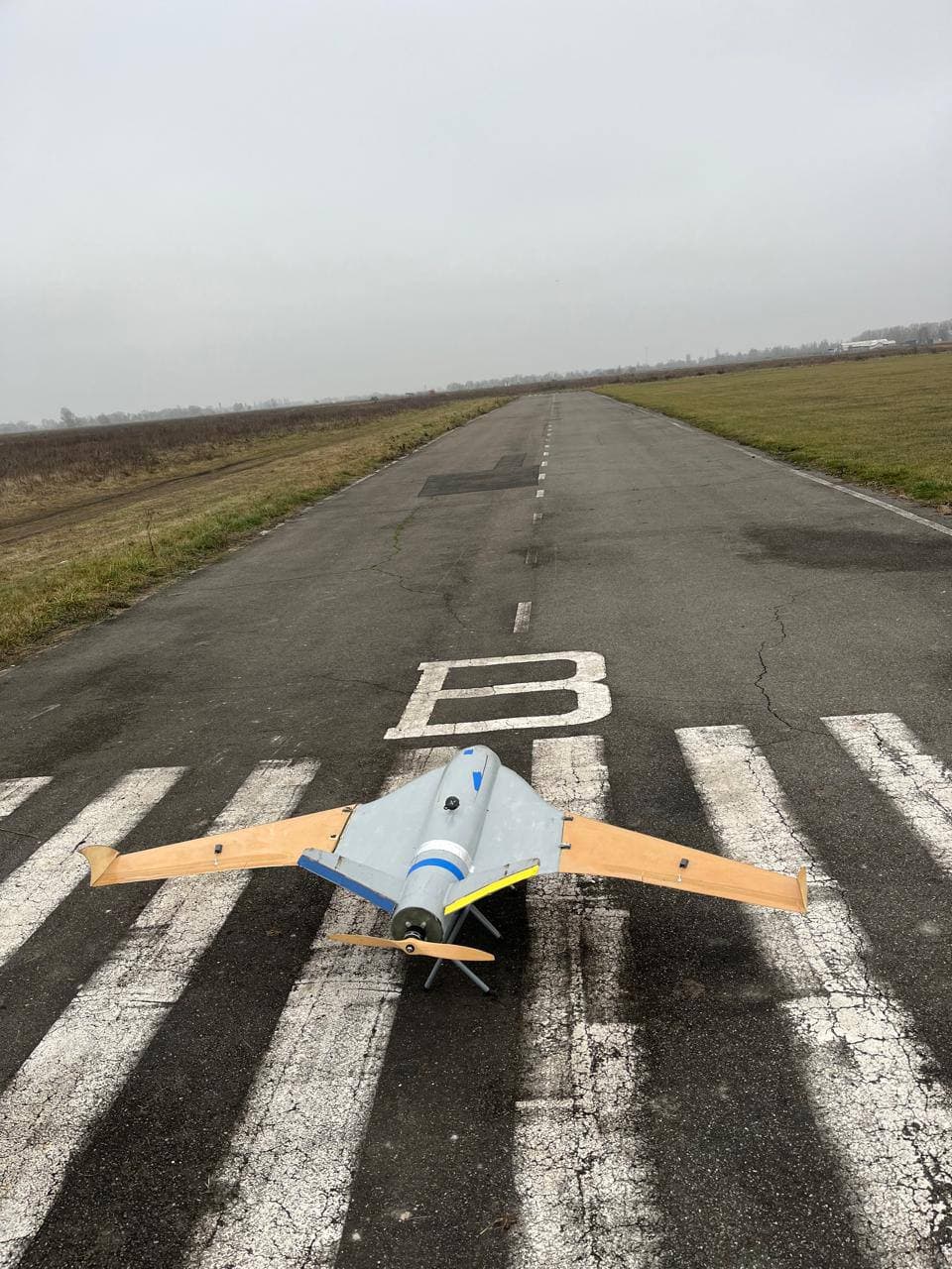 V-tail — top-down runway view, butterfly tail visible