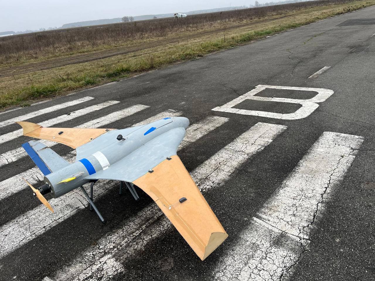 V-tail — angled ground view, wing and fuselage detail